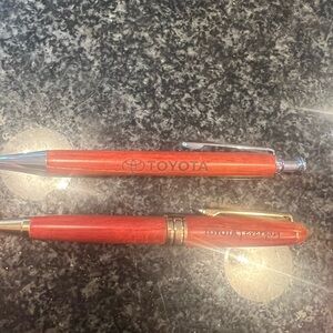 Toyota branded pens includes two wooden. Excellent condition.